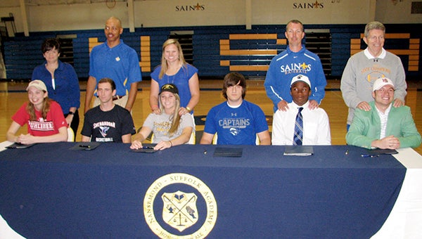 Six student-athletes at Nansemond-Suffolk Academy formalized their commitments to Division III athletic programs in a ceremony Thursday. From left are Caroline Hogg with her coach, Kim Aston; Logan Lokie with his coach, Lamont Strothers; Brooklyne Carr with her coach, Brittany Wilkins; Eric Teumer, whose coach, Lew Johnston, is at the end; Sam Neal with his coach, David Mitchell; and Jack Johnson with Johnston.