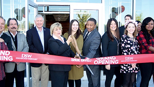 Designer Shoe Warehouse is open for business after Thursday’s ribbon-cutting ceremony. Officials on hand include, from left, Gerald Boone, DSW district manager; Tuck Bowie, president of The Terry Peterson Companies; Suffolk City Councilman Roger Fawcett; Mayor Linda Johnson; Elizabeth Mantovani, DSW store manager; Suffolk City Councilman Lue Ward; Nicole Korabek, DSW project manager; City Manager Patrick Roberts; and DSW sales associates Laura Lentz, Tierney Parker and Shamair Newbitt.