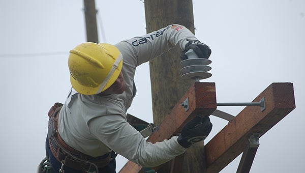 Jonathan Powell leans out to make changes to a cross arm at the 14th annual Gaff-n-Go Lineman’s Rodeo June 3 and 4 in Doswell. (Submitted Photo)