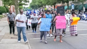 Protestors begin their march down North Main Street about 7:10 p.m. Monday. Many carried signs with slogans such as “Black lives matter,” “All lives matter” and “No justice, no peace.”