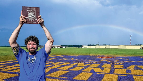 Jason Redman celebrates after being named the winner of Crown Royal's "Your Hero's Name Here" competition during his 100th skydiving jump at Skydive Suffolk. (Photo by Larry French/Getty Images for Crown Royal) 
