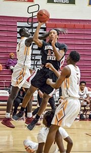 Gerard Stringer takes the ball strong to the rim for the Warriors during their win over Warwick High School. Nansemond River High School ended the regular season on a four-game win streak. Linda Lewis photo